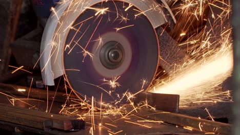 the worker cuts metal pipe with a grinder close-up