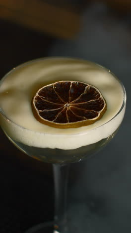 close-up of a cocktail with dried lime