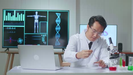 asian scientist researching in the laboratory with a microscope and explain to the camera