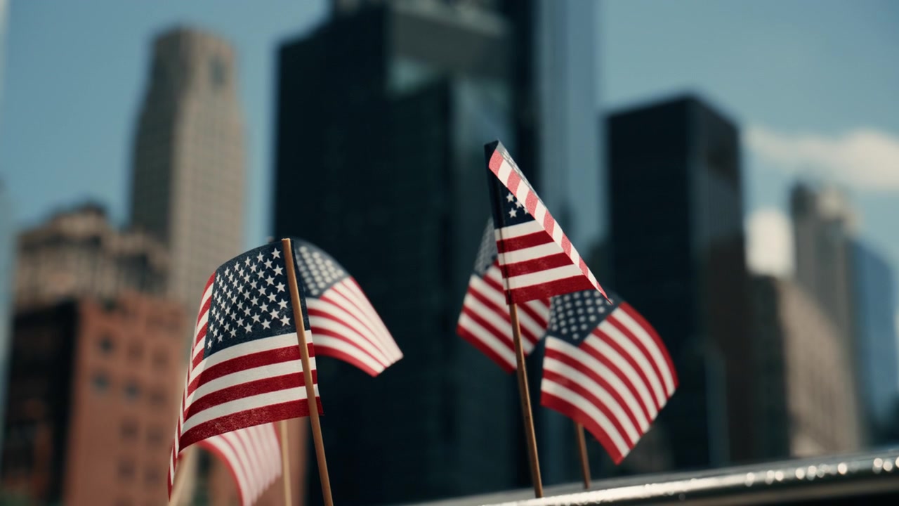 American flags against sunlit building facade and sky