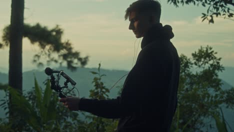 vlogger recording video in nature at sunset
