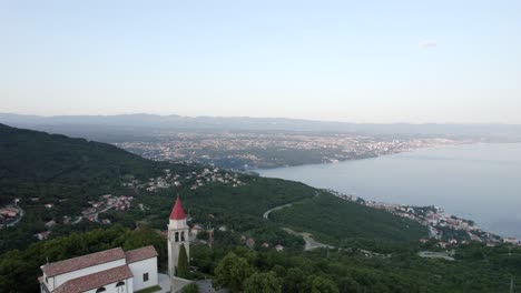 church on hill with scenic bay in background