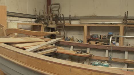 Clinker-built-traditional-sailing-boat-hull-in-shipwright's-shed