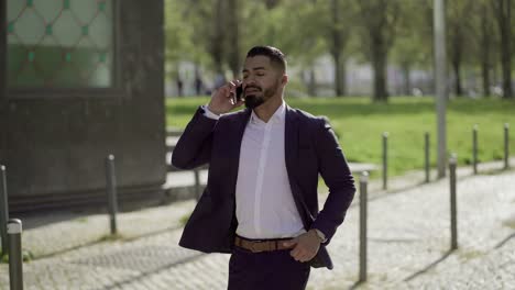 businessman talking by smartphone and running outdoor