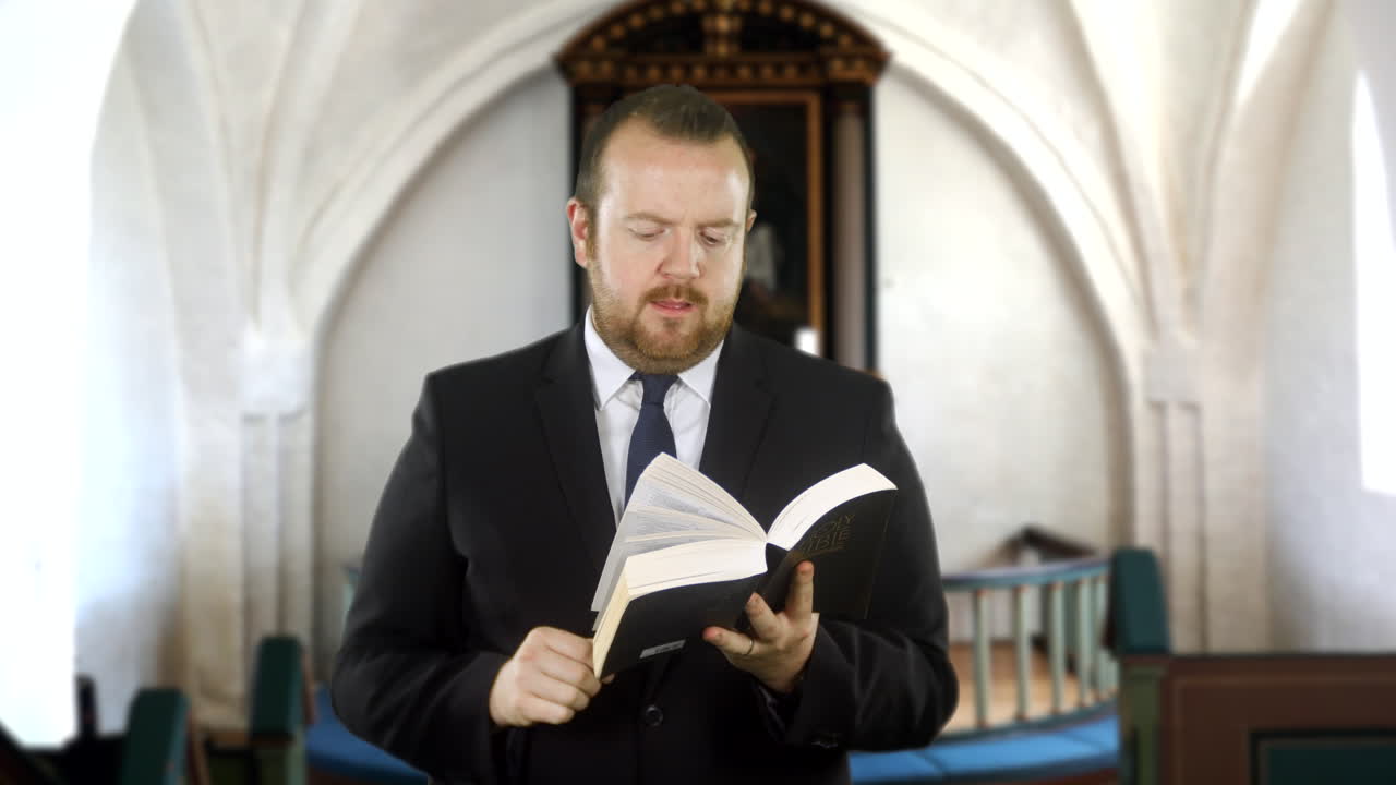A preacher reads from the Holy Bible in church