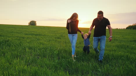 a young couple is having fun with their young child in a picturesque place 2