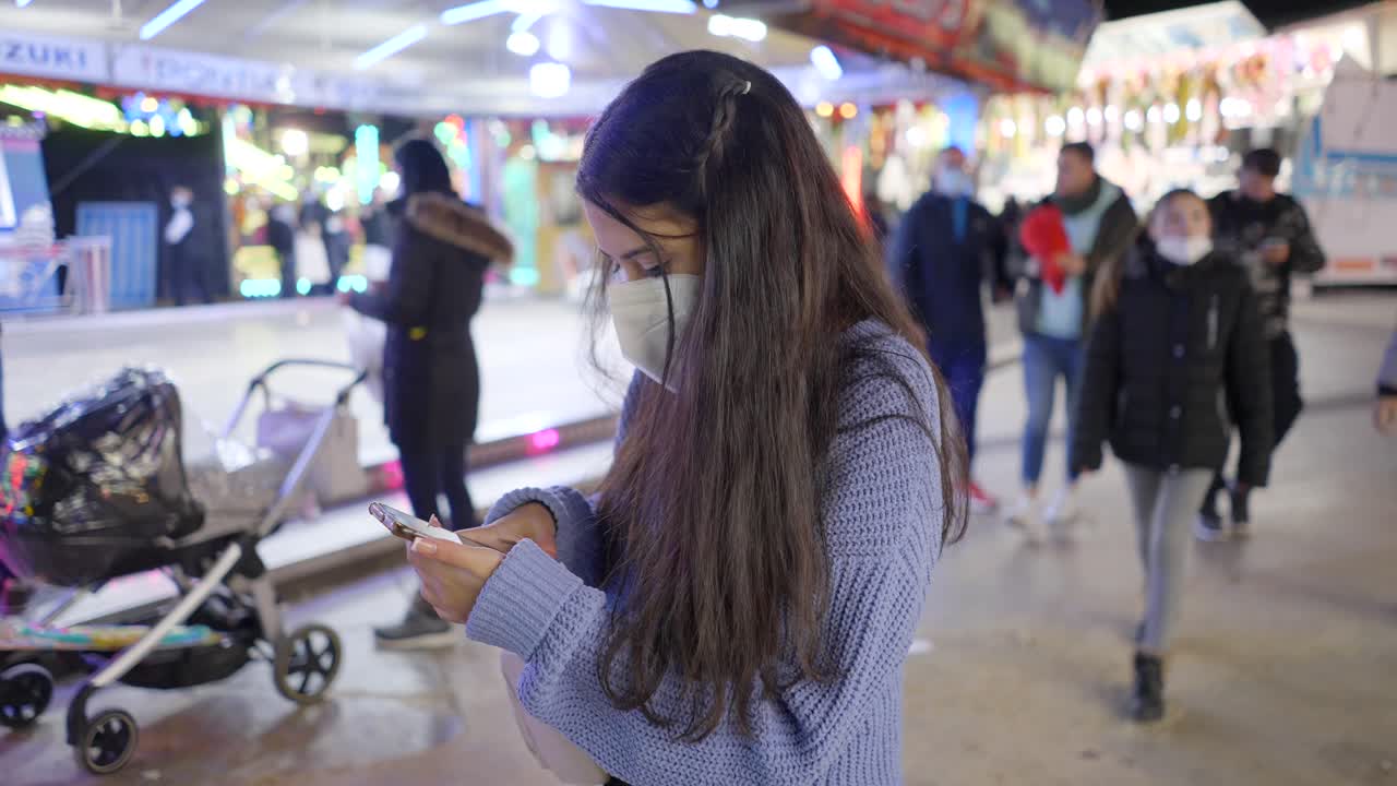 Teenager with Mask at a Night Carnival