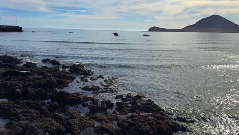 Calm-volcanic-shoreline-in-South-Tenerife-El-Medano,-light-sea-waves