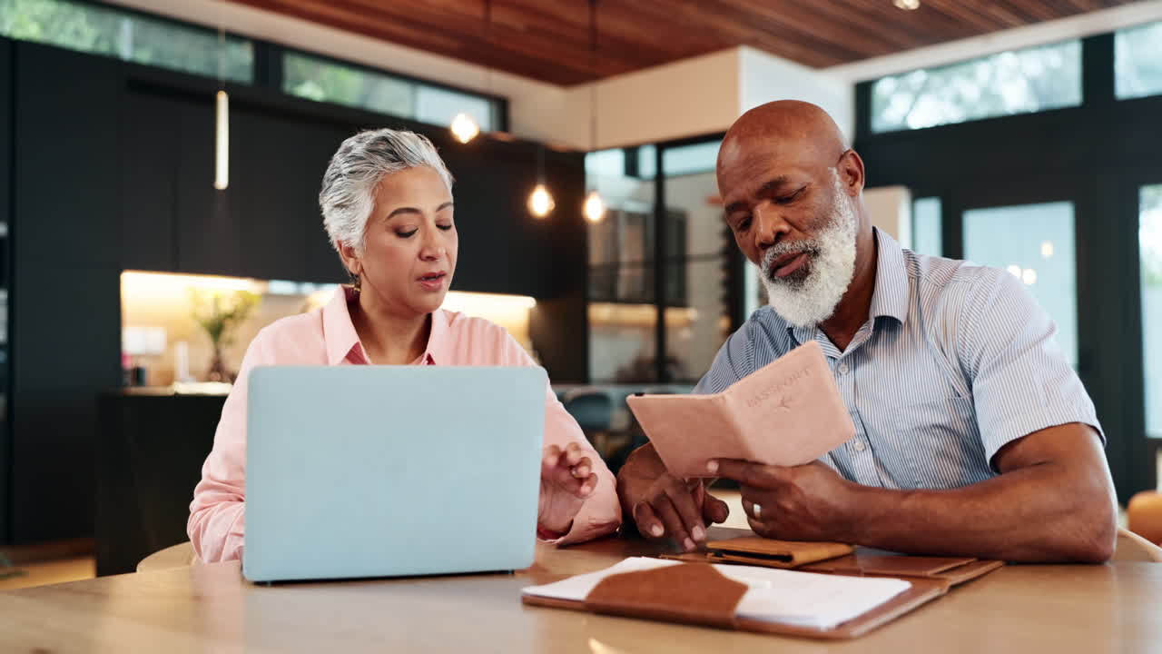 Couple planning travel with laptop and passport