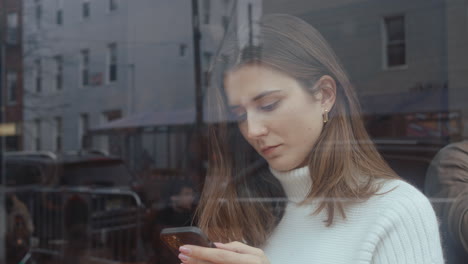mujer usando el teléfono en un café