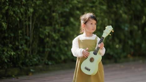 child with musical instrument outdoors