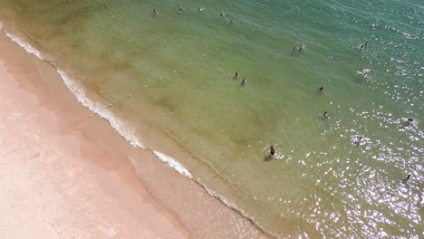 Aerial-view-of-tourists-enjoying-and-sunbathing-at-Pai-Plong-Beach-during-afternoon-in-Krabi,-Thailand