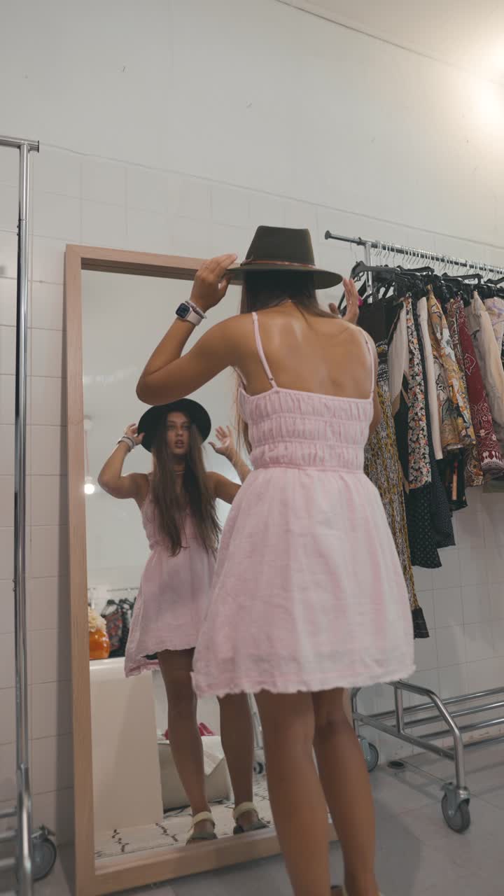 Woman admiring herself in the mirror while shopping