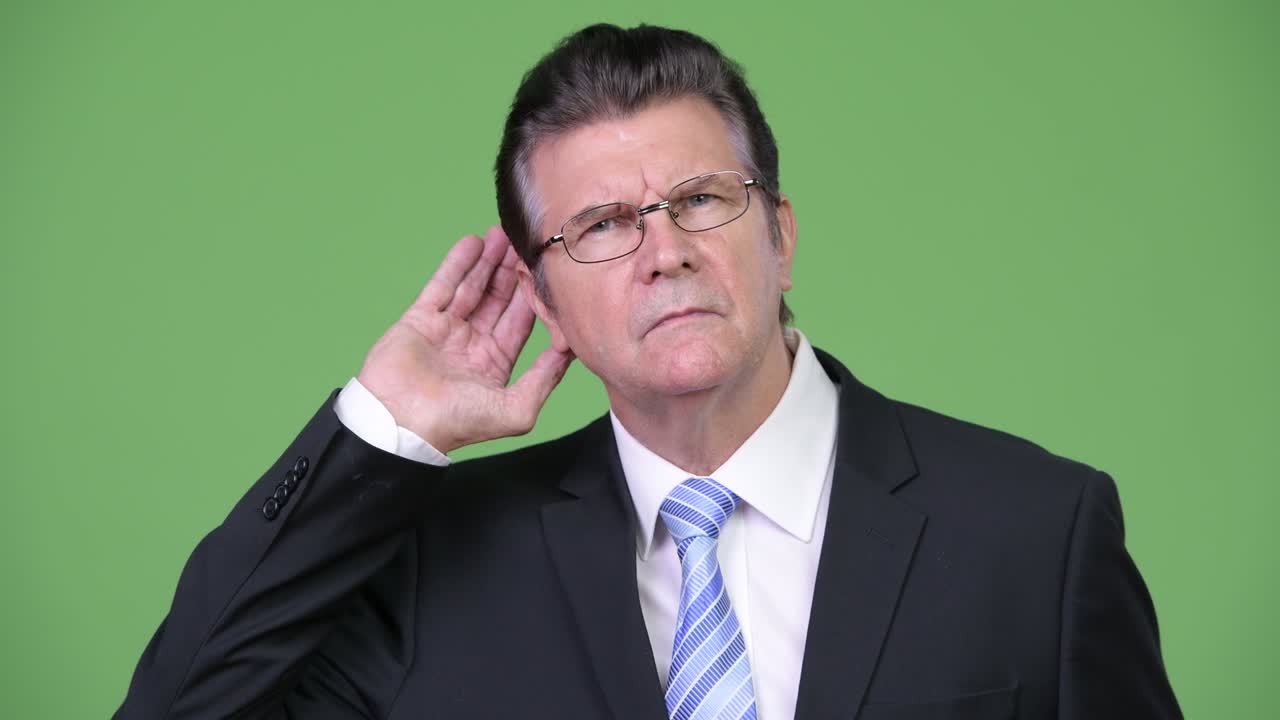 Senior handsome businessman listening