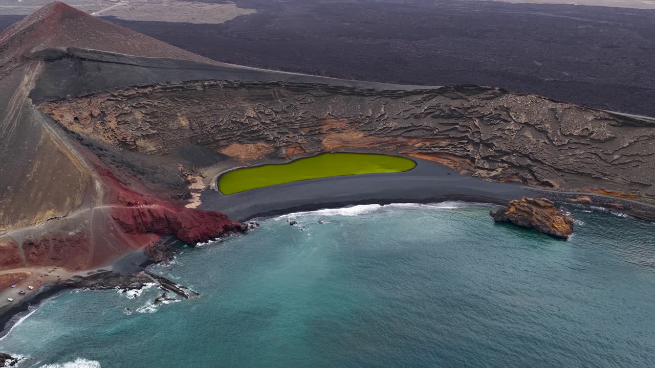 El Golfo's green lagoon and beach under cloudy skies, perfect for travel