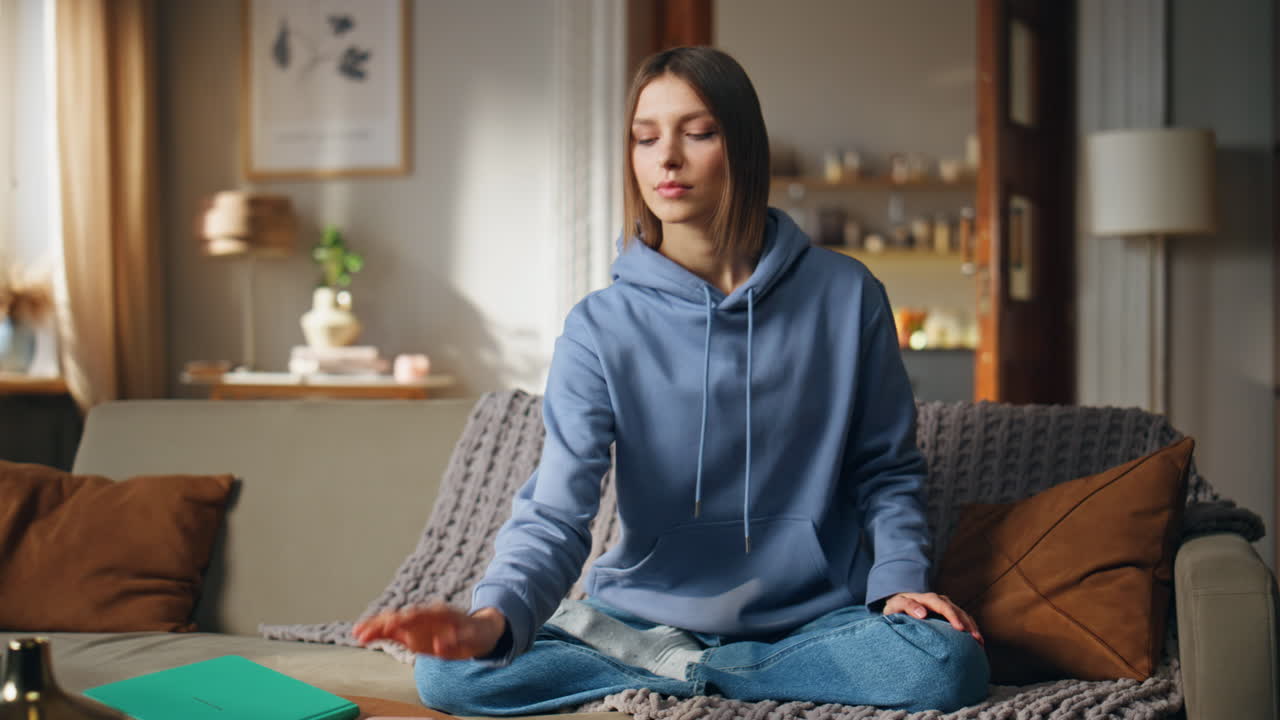 Woman Meditating on Couch