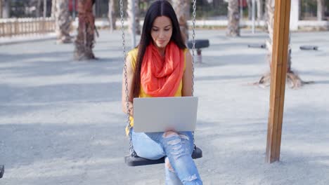 Trendy-young-student-working-in-an-urban-park