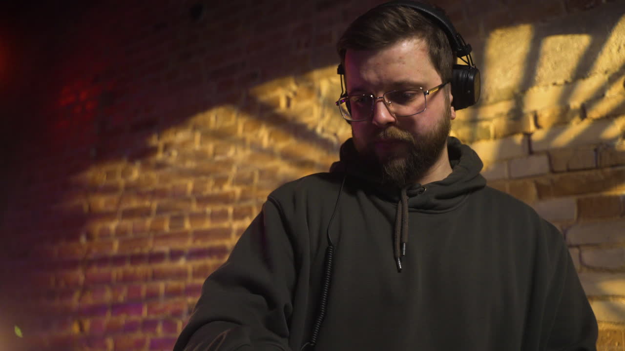 Man with black cap djing at the disco