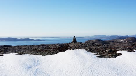 stunning view of fjord from snowy summit of rocky mountain in blaheia, norway