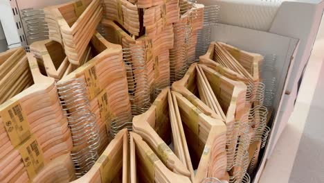 neatly stacked wooden hangers on display shelves