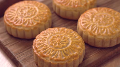 baked cantonese moon cake pastry on a wooden tray for traditional chinese mid-autumn festival.