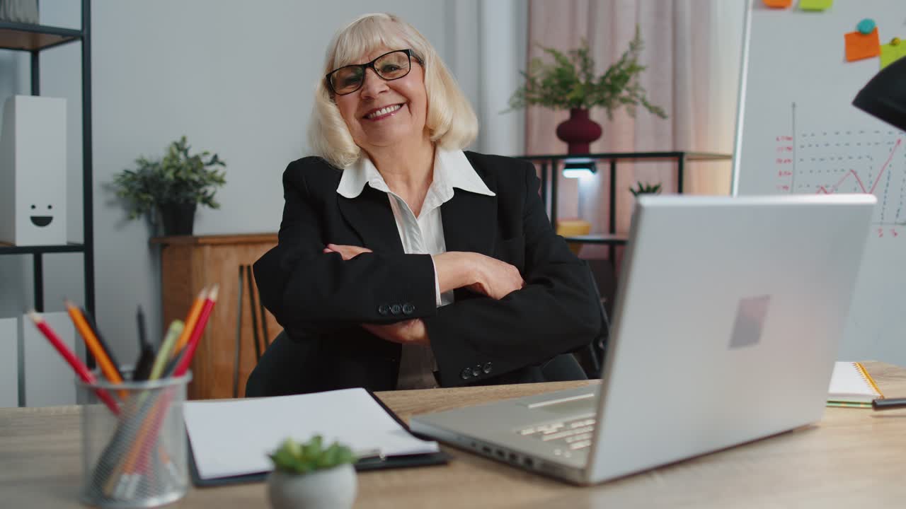 Senior business woman employee outstretching hand to camera offering handshake greeting welcoming
