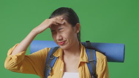 woman with headache and backpack