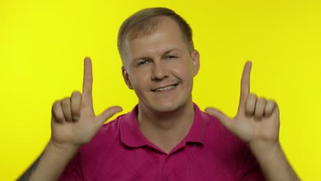 Portrait-of-young-caucasian-man-posing-in-pink-t-shirt.-Happy-handsome-guy-celebrates-and-dances