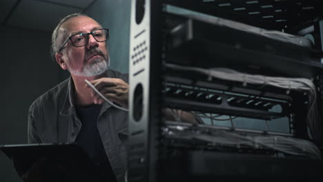 it technician inspecting server room equipment