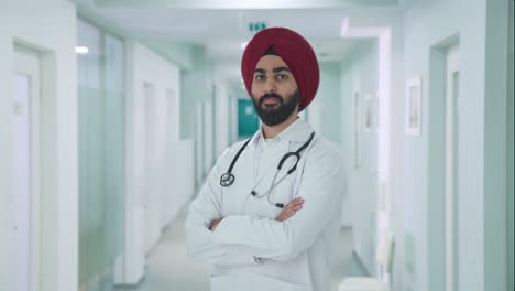 portrait of confident sikh indian doctor standing crossed hands