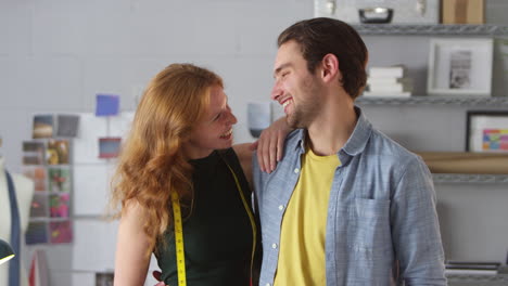 Portrait-Of-Couple-Running-Clothes-Design-Business-Standing-Together-In-Fashion-Studio