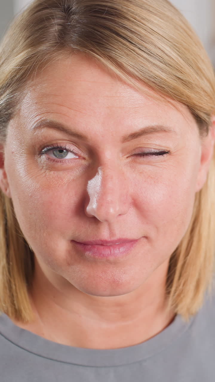 close up caucasian woman grooming eyebrows. Holding tweezers and small scissors, focused expression, natural skin texture, studio lighting, athome beauty routine, esthetician demonstration, confident
