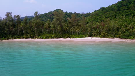 Turquoise-sea-lagoon-of-Koh-Kood-beach-in-Thailand-with-palm-jungle