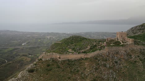 aerial drone panoramic view video of historic uphill medieval castle of acrocorinth an ancient citadel overlooking ancient corinth with breathtaking view, peloponnese, greece