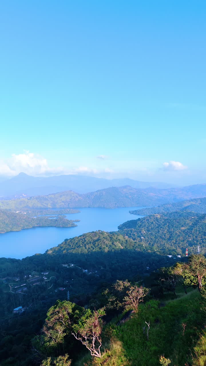 Amazing scenery of Sri Lanka wild nature. Mighty mountains, lush greenery and turquoise waterscapes. Aerial view. Vertical video.