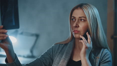 patient talks on phone with doctor looking at x-ray picture