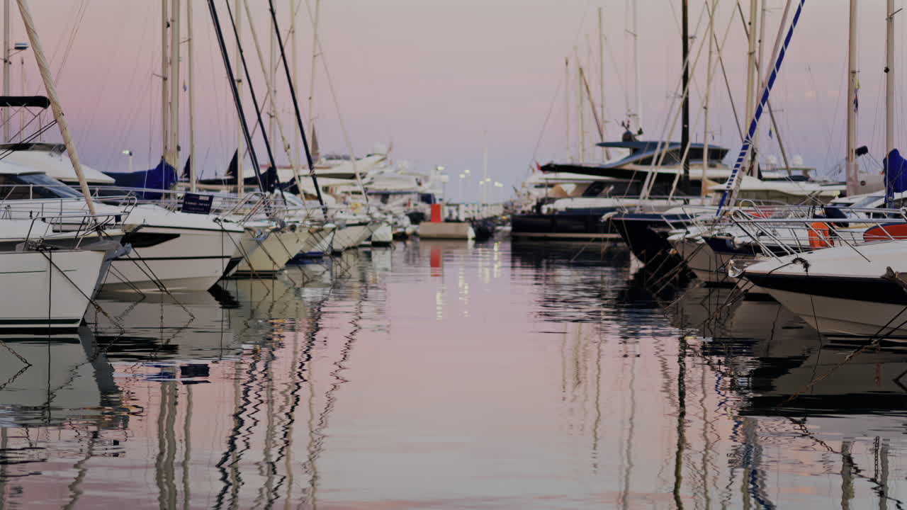 Multiple white boats docked in the Port Vauban at sunset in Antibes, France