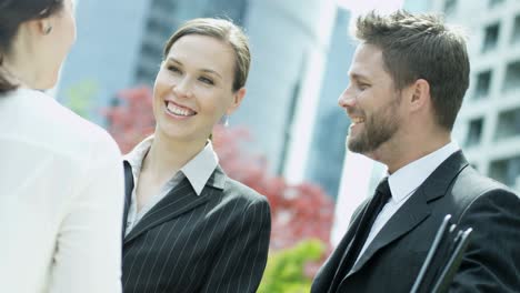 young multi ethnic business executive shaking hands outdoors