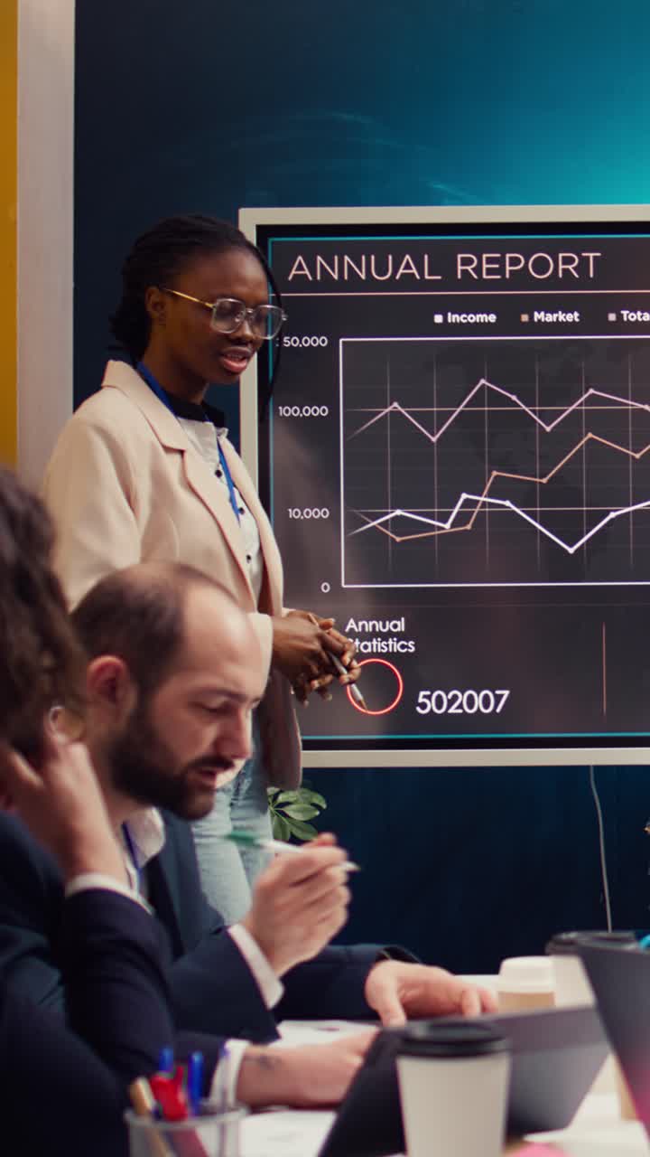 African American Businesswoman Presenting Annual Report to Colleagues in Office