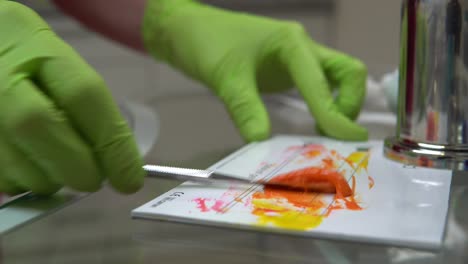 Closeup-view-of-woman's-hands-in-gloves-preparing-medicine-and-resources-for-dental-treatment.-Shot-in-4k