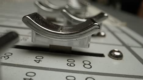 close-up of a hand adjusting faders on an audio mixer