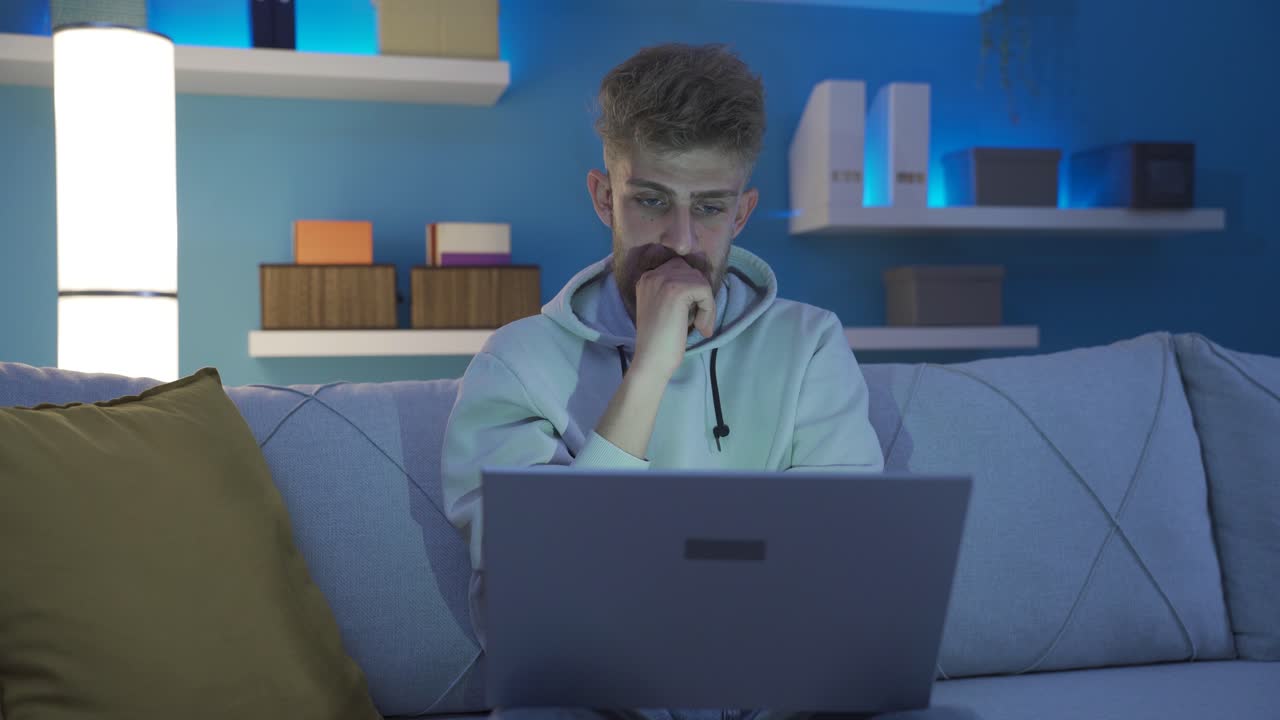 Young man using laptop is worried and stressed.