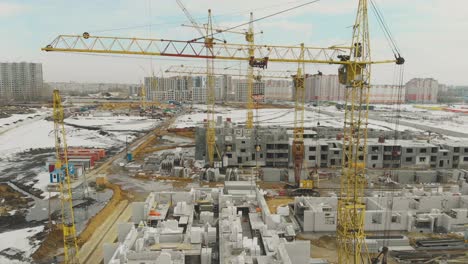 motion above construction site with huge yellow cranes