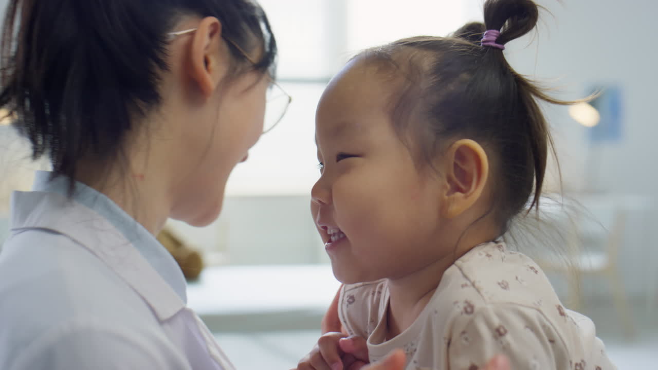Asian Toddler Girl Playing with Pediatrician