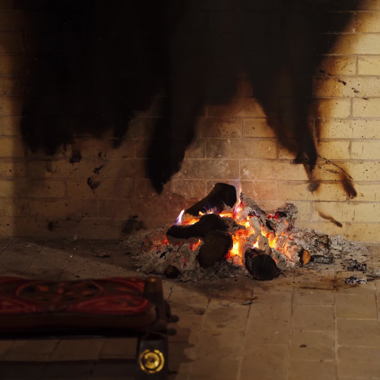 Romantic fire in fireplace. Smoldering logs on pile of ash in home mantel. Burning-out wooden logs. Burning wood in fireplace in winter.