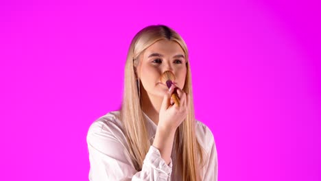 pretty young confident woman gets ready for a date, makeup, purple background