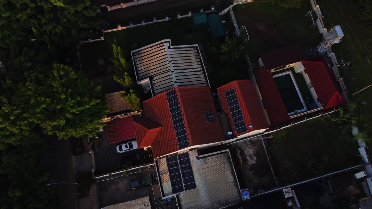 Top down aerial of photovoltaic solar panels on the top of a house in a peaceful suburban neighborhood in Abuja, Nigeria