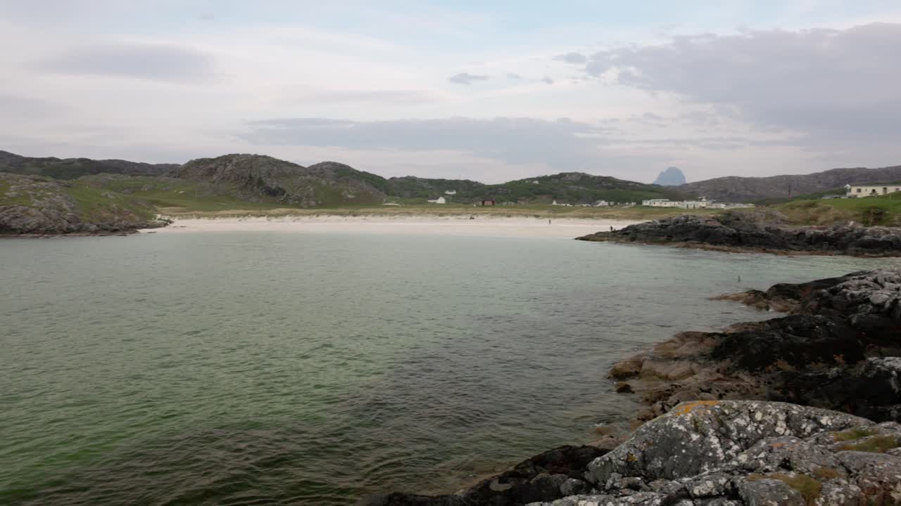 Slow establishing shot of the most famous beach in Scotland at Achmelvich Bay