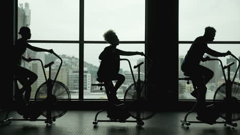 people exercising on air bikes in a gym