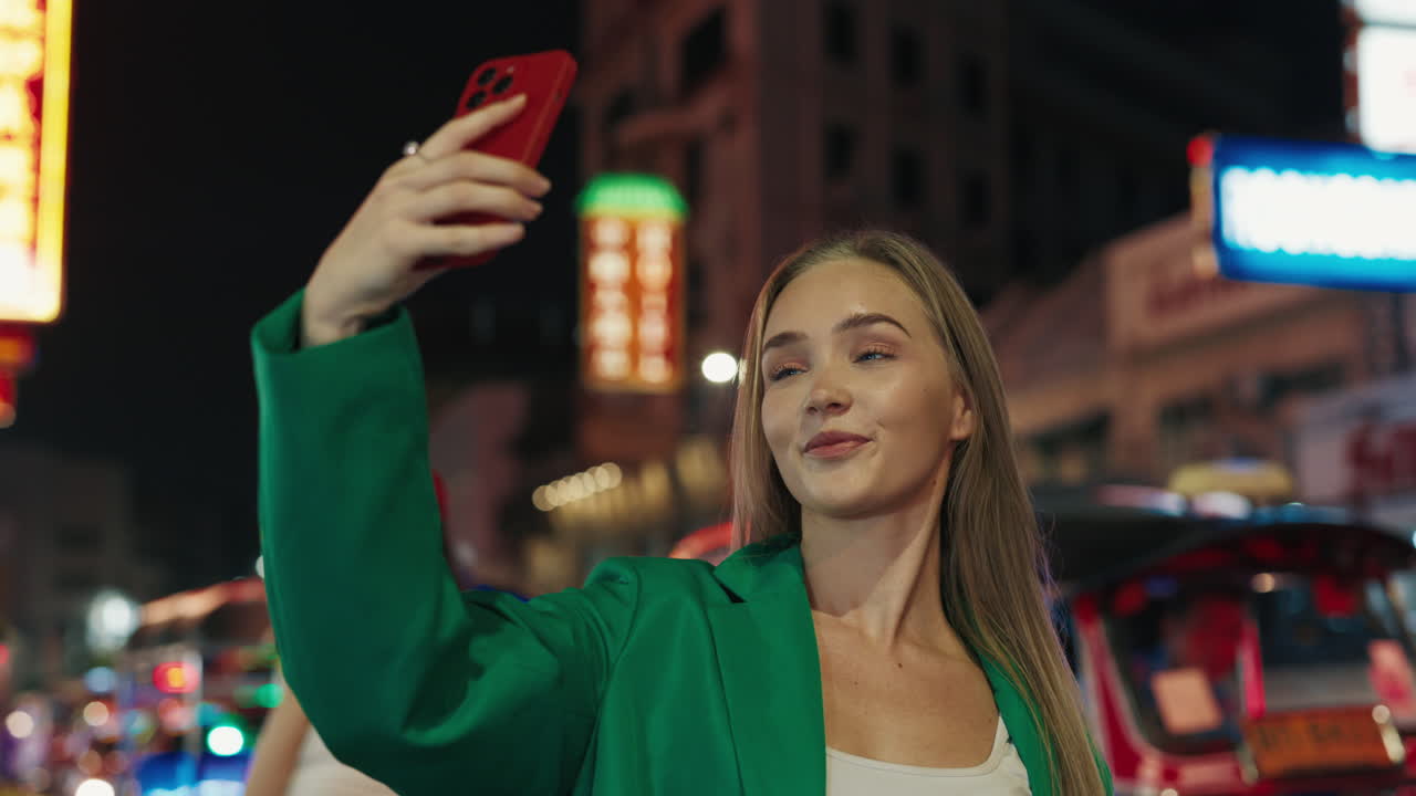 Woman Taking a Selfie at Night Market in Asia